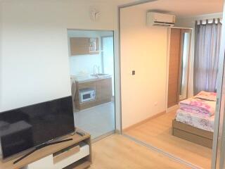 Living area with view into kitchen and bedroom