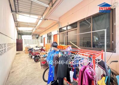 Covered outdoor area with laundry facilities and motorbike parking