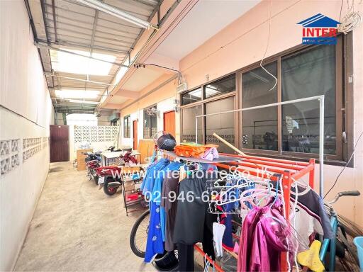 Covered outdoor area with laundry facilities and motorbike parking