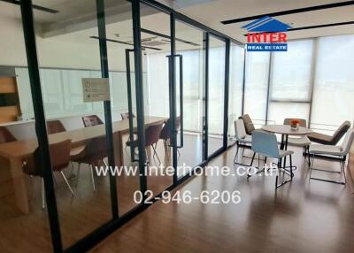 Modern office conference room with large windows and glass partitions