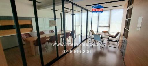 Modern office conference room with large windows and glass partitions