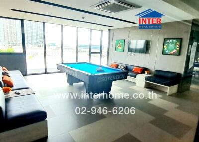 spacious living room with pool table and large windows