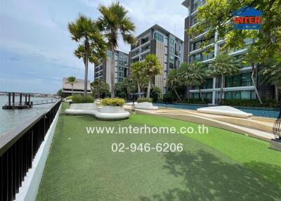 Outdoor garden area near a building with water view