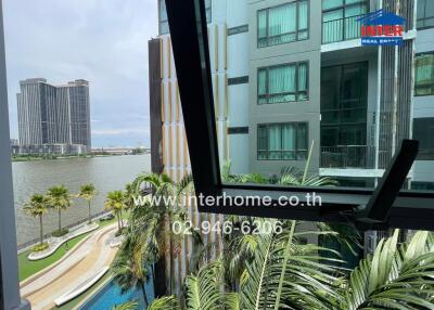 Balcony view overlooking a river and nearby buildings