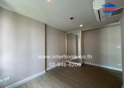 Unfurnished bedroom with wooden flooring and a mirrored wardrobe