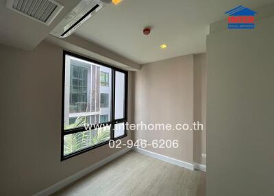 small empty bedroom with large window