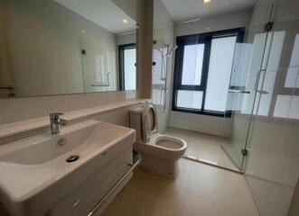 Modern bathroom with large mirror and shower area