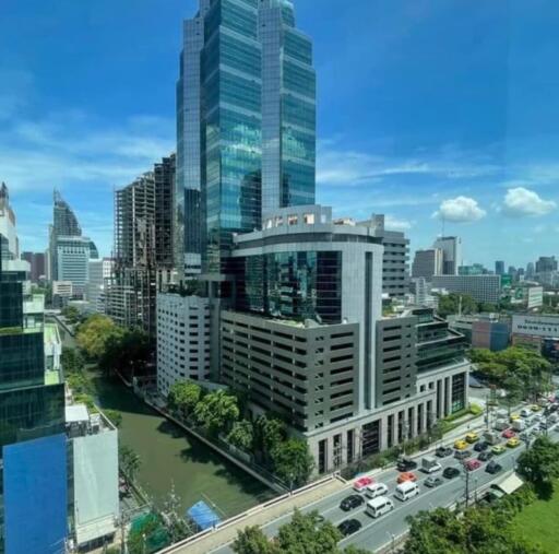 City skyline with modern office buildings and a road full of vehicles