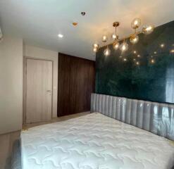 Modern bedroom with decorative lighting and padded headboard