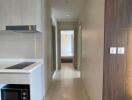 Hallway with kitchenette and view of a bedroom