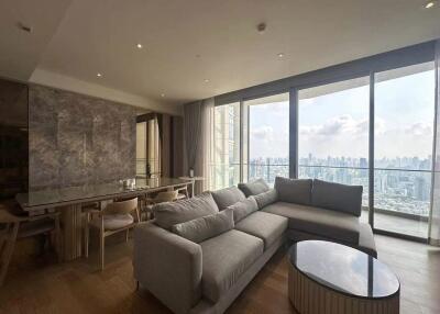 Spacious modern living room with large windows offering city views