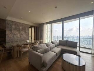 Spacious modern living room with large windows offering city views