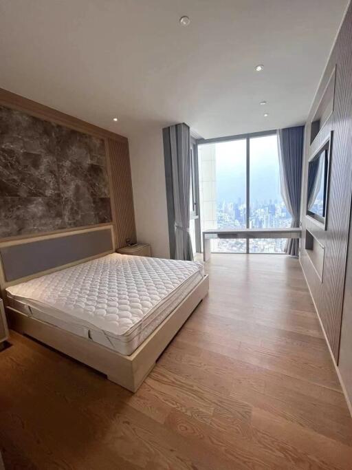 Modern bedroom with large window and city view