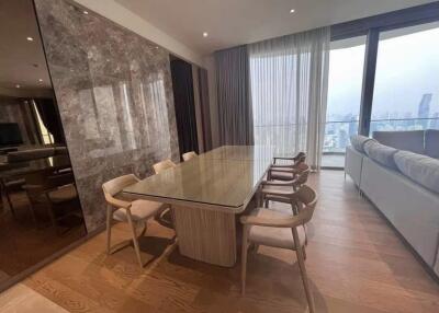 Modern dining room with wooden flooring, large glass table and comfortable chairs