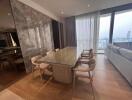 Modern dining room with wooden flooring, large glass table and comfortable chairs