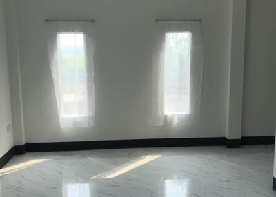 Spacious empty bedroom with two windows