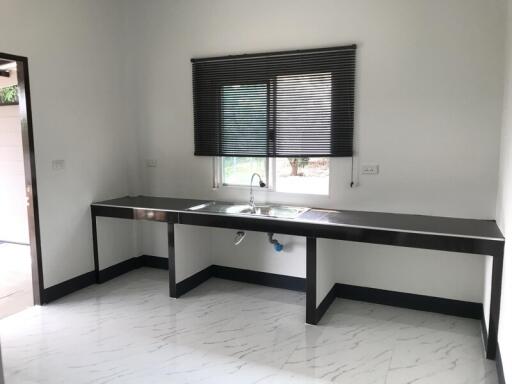 Modern kitchen with window and sleek black countertops