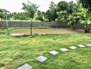 View of the backyard featuring a small pond surrounded by lush greenery