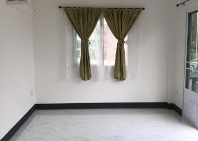 Bright and empty living room with marble floor and green curtains