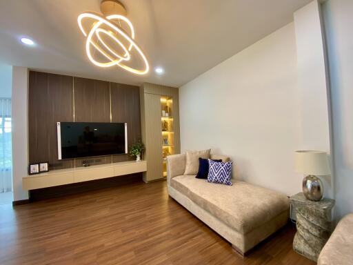 Modern living room with wooden flooring and contemporary lighting