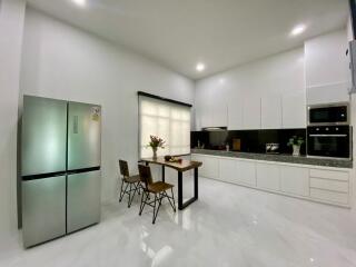 Modern kitchen with stainless steel appliances and dining area