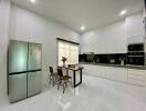 Modern kitchen with stainless steel appliances and dining area