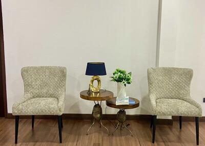 Two chairs with a side table in a living room