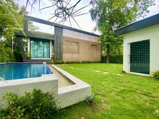 Modern house with swimming pool and grassy lawn