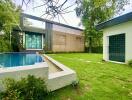 Modern house with swimming pool and grassy lawn