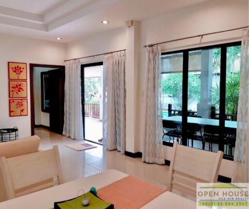 Spacious living room with large windows and a view of the garden