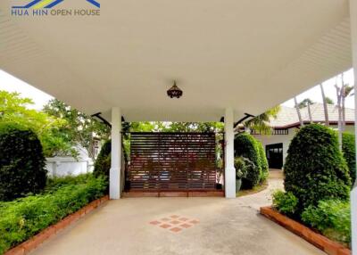 Covered driveway with garden view