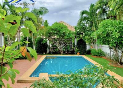 Beautiful outdoor area with a swimming pool surrounded by lush greenery