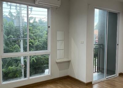 Bright living room with large windows and balcony access