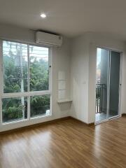 Bright living room with large windows and balcony access