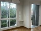 Bright living room with large windows and balcony access