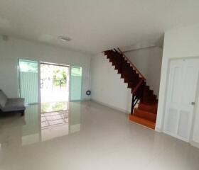 Spacious living room with stairs and large windows