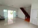 Spacious living room with stairs and large windows