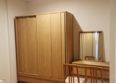 Bedroom with wooden wardrobe and dressing table