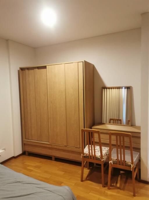 Bedroom with wooden wardrobe and dressing table