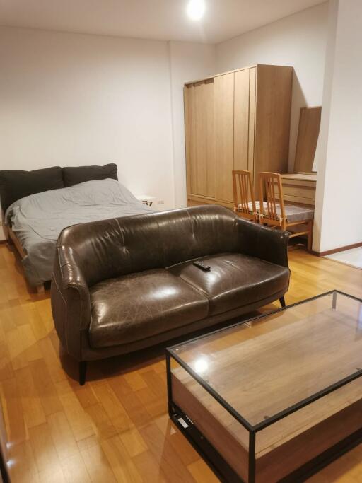 Studio apartment with bed, sofa, and dining table