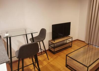 Modern living room with glass furniture and TV