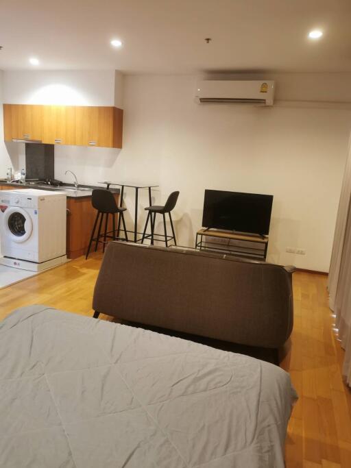 Studio apartment with combined living, kitchen, and sleeping area