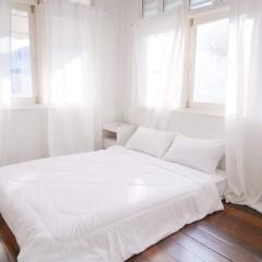 Bright and airy bedroom with natural light and white decor