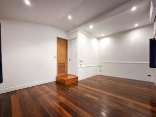 Spacious living area with wooden flooring and recessed lighting