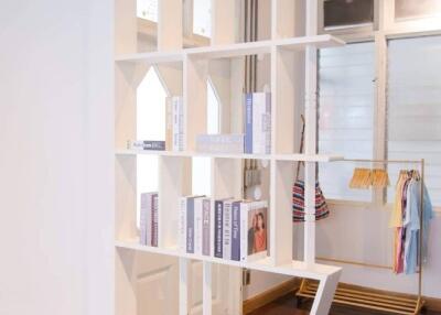 Modern interior with wooden flooring and shelving unit