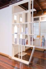 Modern interior with wooden flooring and shelving unit