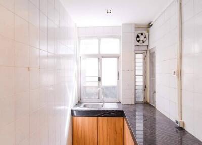 Bright kitchen with marble countertop and large windows