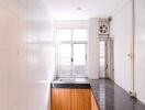 Bright kitchen with marble countertop and large windows