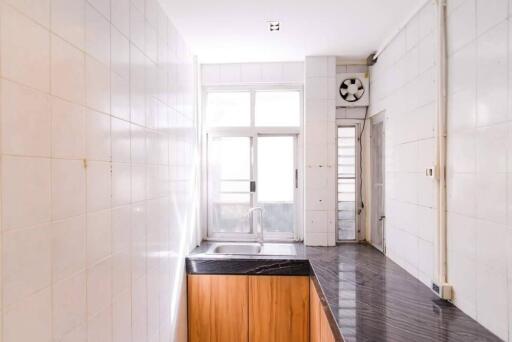 Bright kitchen with marble countertop and large windows