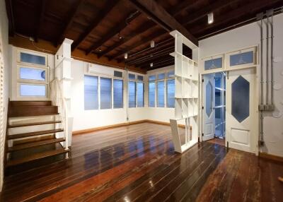 Spacious living room with wooden flooring and staircase